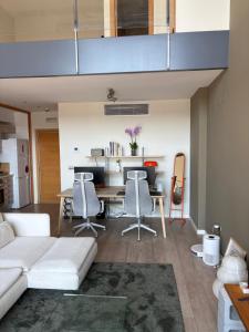 a living room with a white couch and a table at Loft en Valencia in Burjassot