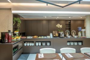 a restaurant with tables and chairs and a counter at Palazzo Vittoria Hotel Milano in Milan