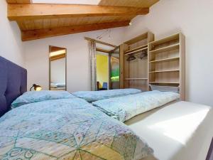 two beds in a bedroom with wooden ceilings at Apartment Vöstl by Interhome in Navis