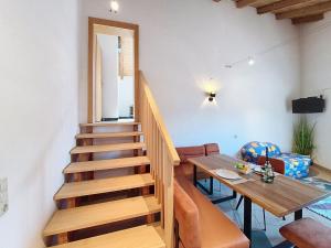a staircase in a room with a table and a dining room at Apartment Vöstl by Interhome in Navis