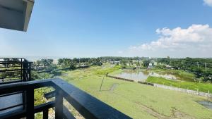 a view of a golf course from a balcony at Hotel Inani Long Bay in Cox's Bazar