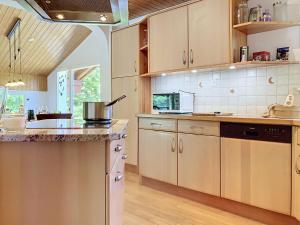 a kitchen with wooden cabinets and a counter top at Chalet Chalet Chaudoudoux - Les Paccots by Interhome in Les Paccots +17 photos