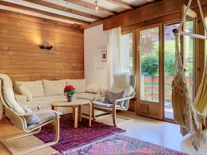 a living room with a couch and chairs and a table at Chalet Chalet Chaudoudoux - Les Paccots by Interhome in Les Paccots