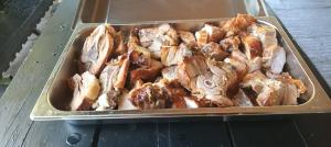 a tray filled with chicken and other food items at Hiška Nika in Malečnik