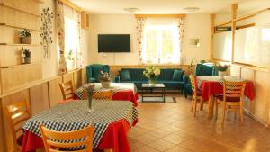 a living room with two tables and a couch at Bed&Breakfast AmWeinberg in Gamlitz