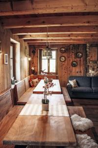 a living room with a table and a couch at by Interhome in Bedollo