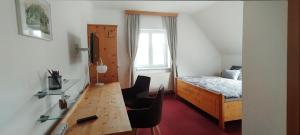 a bedroom with a desk and a bed and a window at Bed&Breakfast AmWeinberg in Gamlitz