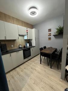 a kitchen and dining room with a table at Apartament nad rzeką in Głuszyca +5 photos