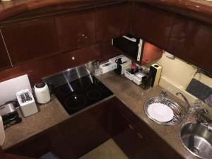 a small kitchen with a stove and a sink at The Duke Superyacht - LINDIAN in Lindos