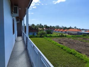 a balcony of a house with a yard at MD Amed Guest House in Amed