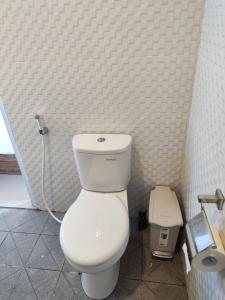 a bathroom with a white toilet in a room at MD Amed Guest House in Amed +4 photos