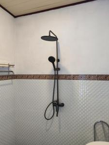 a stand up shower in the corner of a bathroom at MD Amed Guest House in Amed