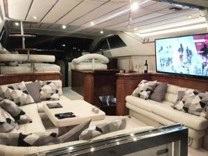 a living room with a couch and a flat screen tv at The Duke Superyacht - LINDIAN in Lindos
