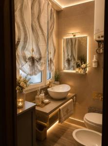 a bathroom with a sink and a toilet and a mirror at Da Leo & Mia in Modena +11 photos