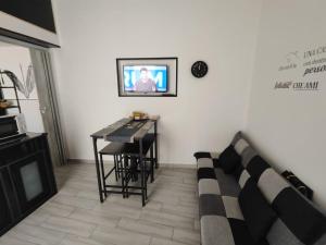 a living room with a couch and a tv on a wall at Magic House in Palermo +42 photos