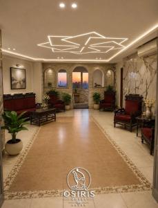 a lobby with chairs and tables in a building at Osiris Hotel Downtown in Cairo