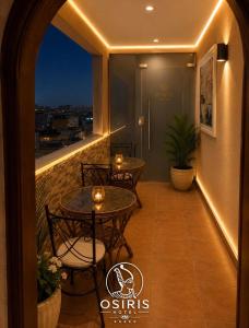 a balcony with two tables and a view at Osiris Hotel Downtown in Cairo