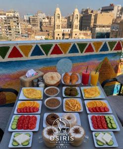 a table with different types of food on it at Osiris Hotel Downtown in Cairo
