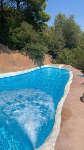 an overhead view of a blue swimming pool on a beach at Aldea Roqueta Hotel Rural in Els Ibarsos
