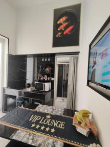 a kitchen with a tv and a table with bananas on it at Magic House in Palermo
