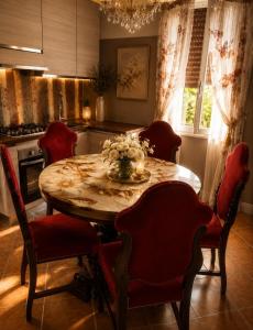 a kitchen with a wooden table with red chairs at Da Leo & Mia in Modena