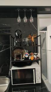 a kitchen with a microwave and some pots and pans at Magic House in Palermo
