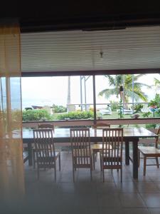 a table and chairs with a view of the ocean at Maupiti Authentique in Te-Fare-Arii