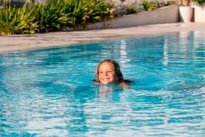 a young girl swimming in a swimming pool at Residence Stellaris Apartrooms in Termoli +122 photos