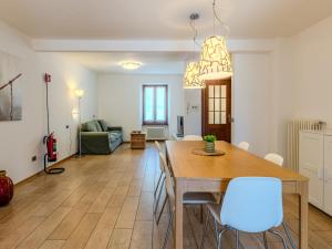 a dining room and living room with a table and chairs at Apartment Legnone by Interhome in Sorico +36 photos
