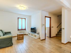 a living room with a couch and a television at Apartment Legnone by Interhome in Sorico