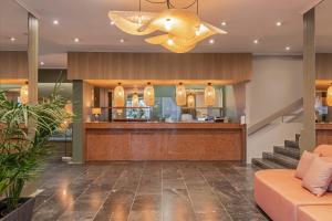 a lobby of a hotel with a counter and a bar at Dorisol Buganvilia Studio Hotel in Funchal +56 photos