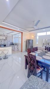 a kitchen and dining room with a table and chairs at J&T Holme Villa in Galu