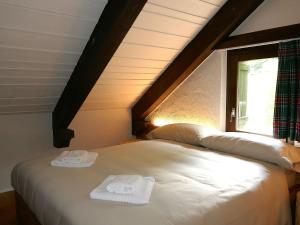 a bed in a room with two towels on it at Apartment Apt- Terrace by Interhome in Olivone