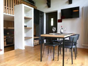 a dining room with a table and chairs and a kitchen at Apartment Apt- Terrace by Interhome in Olivone +33 photos