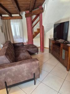 a living room with a couch and a flat screen tv at Kuća za odmor Silba in Silba