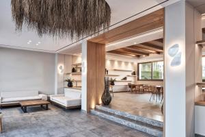 a living room with a couch and a table at Atlantica Beach Resort Kos in Kardamaina