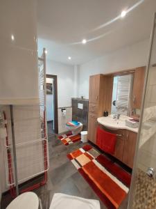 a bathroom with a sink and a shower and a toilet at Ferienwohnung Kasbacher in Bruck an der Großglocknerstraße +18 photos