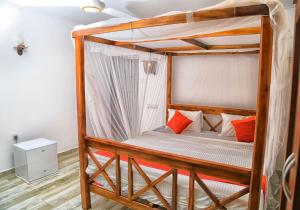 a bedroom with a wooden bunk bed with orange pillows at Villa Kandy with Private Pool in Kandy