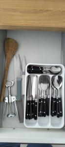 a white drawer filled with utensils in a kitchen at Gîte du Tilleul in Beire-le-Châtel
