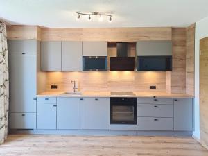 a kitchen with white cabinets and a sink at Apartment Eben by Interhome in Hippach +27 photos