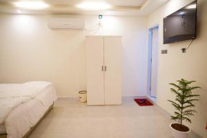a bedroom with a bed and a tv on a wall at Sun Oasis Resort in Cox's Bazar
