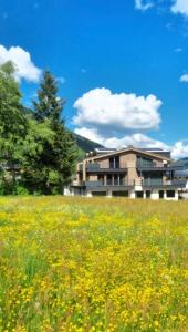 a field of flowers in front of a building at B living Apartments in Neukirchen am Großvenediger