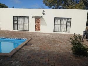 a house with a swimming pool in front of it at Stay at Gabby's- no loadshedding in Cape Town
