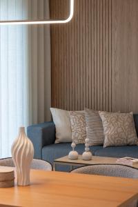 a living room with a couch and a table at Kleopatra Homes - Napoleontos in Messini