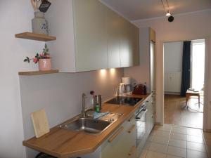 a kitchen with a sink and a counter at Ferienwohnungen direkt am Schmollensee in Bansin +13 photos