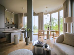 a living room with a couch and a table at THE BALTIC VIEW Sellin in Ostseebad Sellin