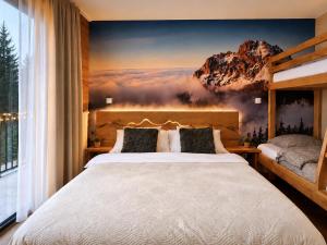 a bedroom with a large bed and a mountain mural at Apartmán Dubový důl in Černý Dŭl