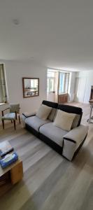 a living room with a couch and a table at Gîte du Tilleul in Beire-le-Châtel