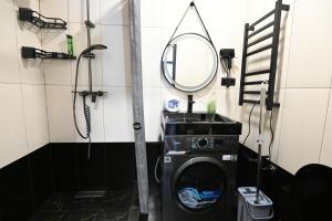a bathroom with a washing machine and a mirror at Jivani 105 in Gyumri +18 photos