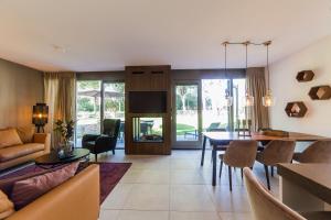 a living room with a table and a dining room at Dormio Resort Maastricht in Maastricht
